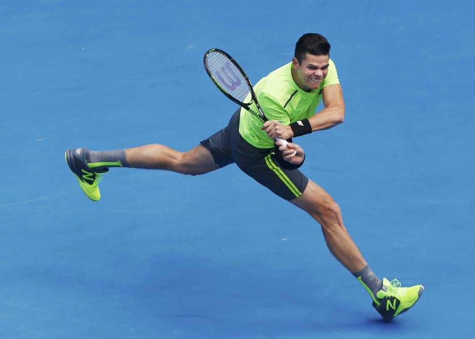 Raonic of Canada hits a return to Lopez of Spain during their men's singles match at the Australian Open 2015 tennis tournament in Melbourne