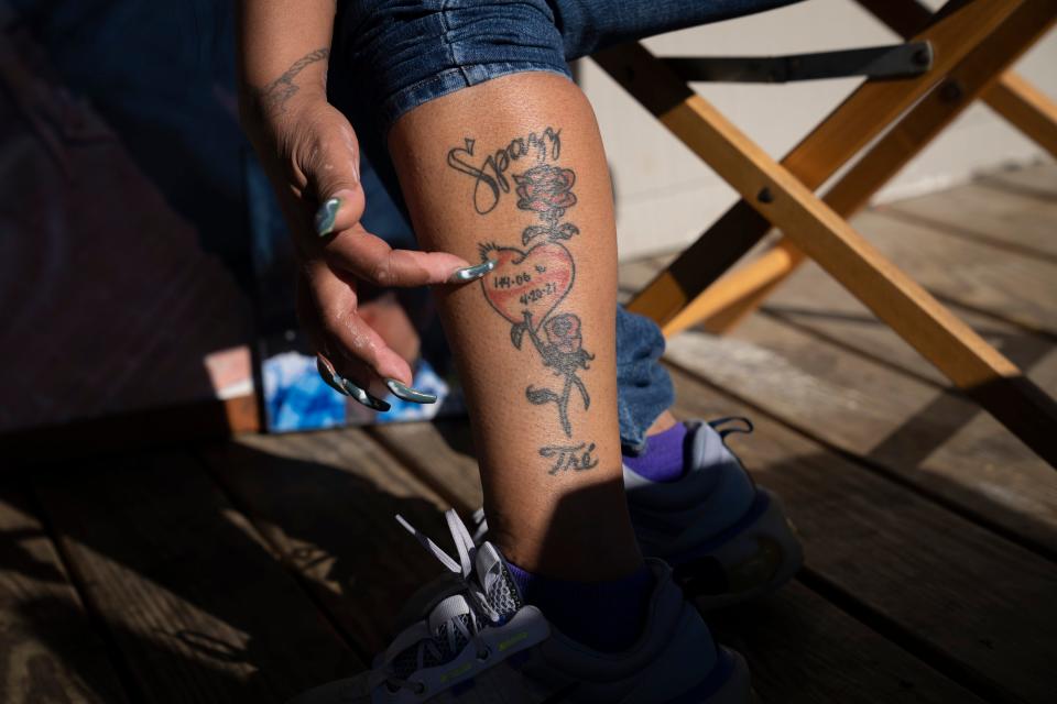 Shawna Brady shows the tattoo she first got for her son, TréVon Dickson, when he was 2 years old. After he was fatally shot on April 20, 2021, she eventually had the date of his death added to the tattoo along with her son's nickname, Spazz.