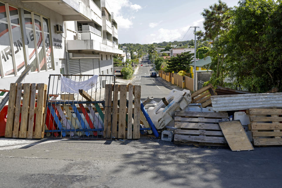 A road block in central Noumea, New Caledonia, Thursday, May 23, 2024. French President Emmanuel Macron has landed in riot-hit New Caledonia, having crossed the globe by plane from Paris in a high-profile show of support for the French Pacific archipelago wracked by deadly unrest and where indigenous people have long sought independence from France. (Ludovic Marin/Pool Photo via AP)