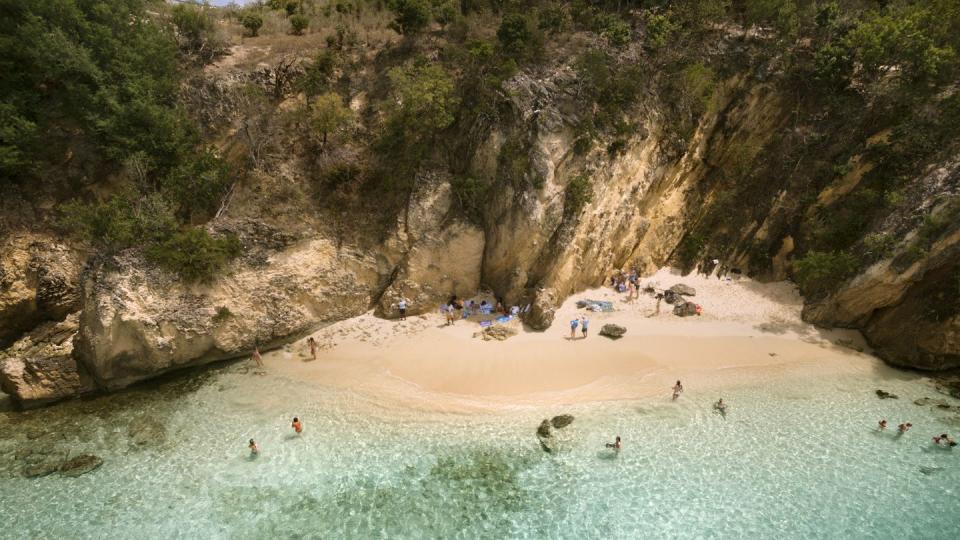 high angle view of people enjoying in sea against cliff