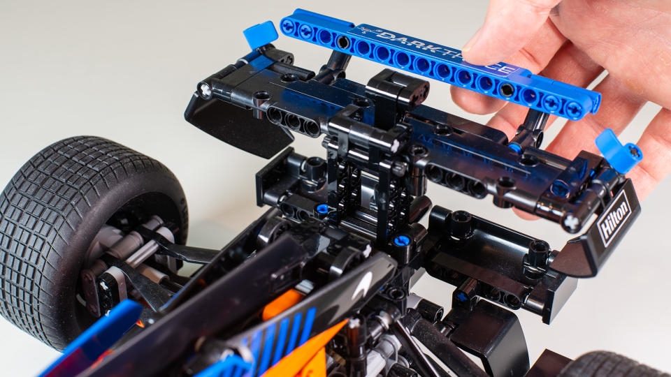 A hand opening the working DRS on the Lego Technic McLaren Formula 1 Race Car