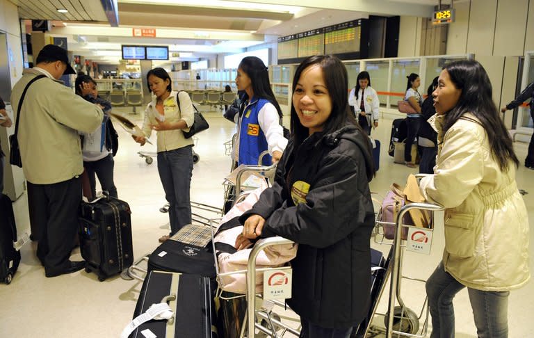 A group of workers from the Philippines arrive at Taipei's airport, on March 14, 2008. There are currently 87,000 Philippine workers in Taiwan and labour authorities said nearly 2,000 new applications are submitted monthly