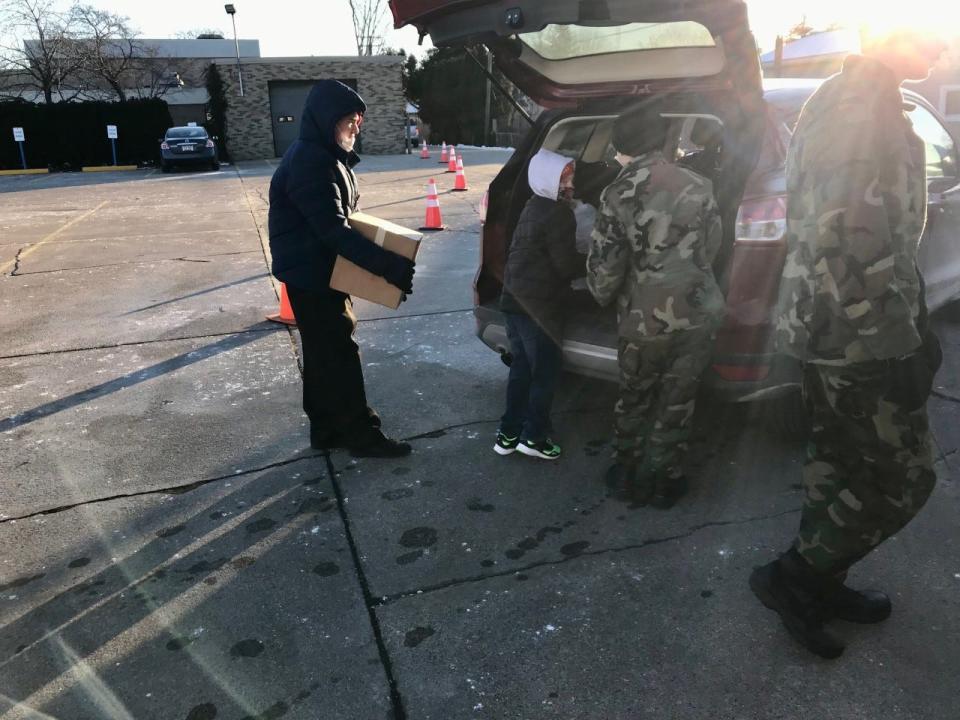 Young Marines load food into people's trunks for the annual Salvation Army distribution day on Wednesday, Dec. 22, 2021.