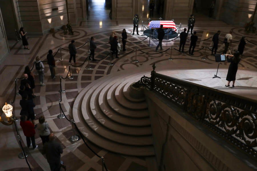 Members of the public await their turn to pay respects as the casket of the late Sen. Dianne Feinstein in the Rotunda of City Hall in San Francisco, Wednesday, Oct. 4, 2023. (Jessica Christian/San Francisco Chronicle via AP)