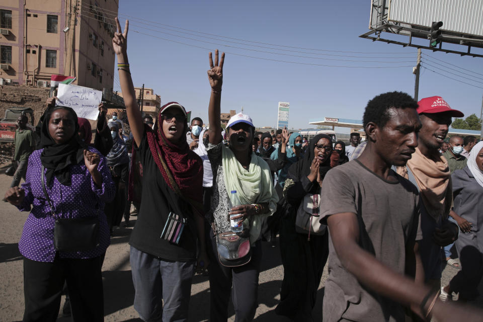 Thousands of protesters take to the streets to renew their demand for a civilian government in the Sudanese capital Khartoum, Thursday, Nov. 25, 2021. The rallies came just days after the military signed a power-sharing deal with the prime minister, after releasing him from house arrest and reinstating him as head of government. The deal came almost a month after the generals orchestrated a coup. Sudan’s key pro-democracy groups and political parties have dismissed the deal as falling short of their demands for a fully civilian rule. (AP Photo/Marwan Ali)