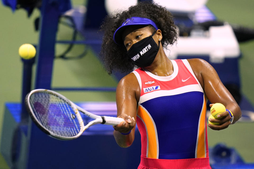 Naomi Osaka, of Japan, hits balls into the stands after defeating Anett Kontaveit, of Estonia, during the fourth round of the US Open tennis championships in New York on Sept. 7, 2020. (AP Photo/Frank Franklin II)