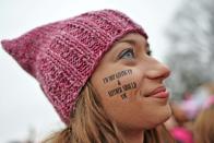 Washington's Metro stations were overwhelmed as trains packed to bursting ferried cheering, clapping marchers into the city -- many wearing knitted "pink pussyhats"