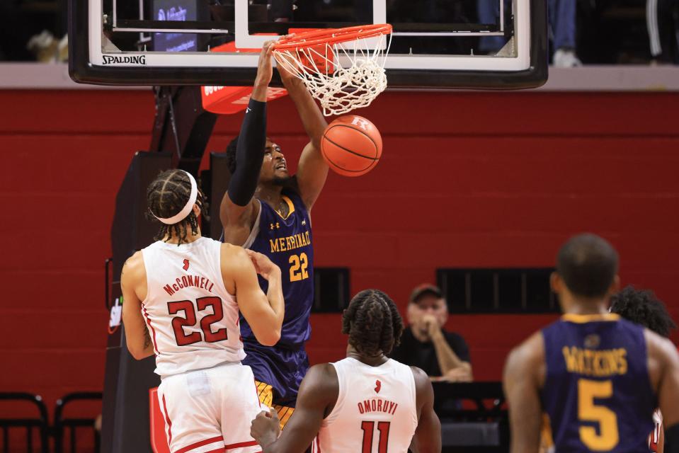 Nov 13, 2021; Piscataway, New Jersey, USA; Merrimack Warriors forward Jordan Minor (22) dunks the ball in front of Rutgers Scarlet Knights guard Caleb McConnell (22) and center Cliff Omoruyi (11) during the first half at Jersey Mike's Arena.