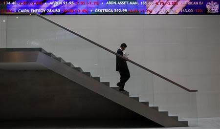 A man walks down steps under a share price ticker at the London Stock Exchange in the City of London November 1, 2011. REUTERS/Andrew Winning