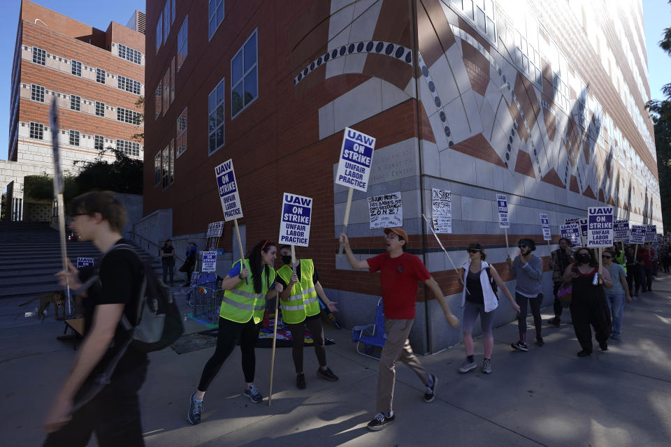 People participate in a protest outside of the University of California Los Angeles, UCLA campus in Los Angeles, Monday, Nov. 14, 2022. Nearly 48,000 unionized academic workers at all 10 University of California campuses have walked off the job Monday. (AP Photo/Damian Dovarganes)