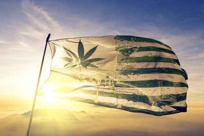 An American flag with a cannabis leaf in place of the stars blowing in the wind.