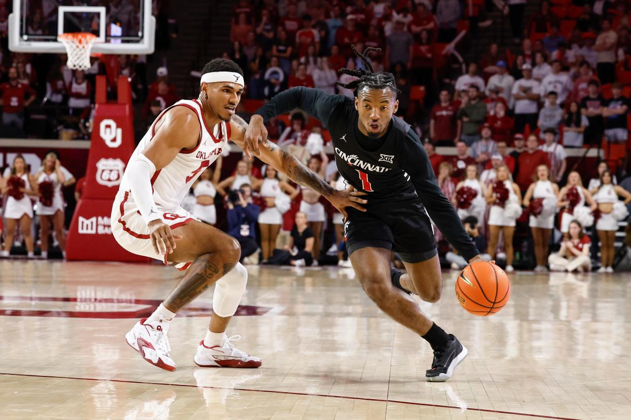 Mar 5, 2024; Norman, Oklahoma, USA; Cincinnati Bearcats guard Day Day Thomas (1) moves the ball around Oklahoma Sooners guard Rivaldo Soares (5) during the first half at Lloyd Noble Center.