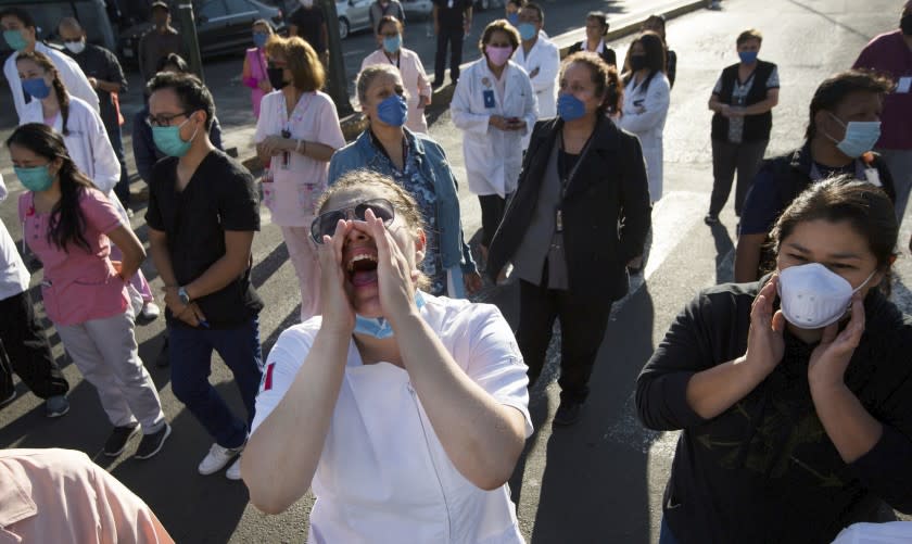 Public hospital workers shout to demand protective gear and training as they protest outside a public hospital in Mexico City, Monday, April 13, 2020. Doctors, nurses and other personnel have demonstrated at a number of public hospitals around the country as the new coronavirus sickens medical personnel. (AP Photo/Fernando Llano)