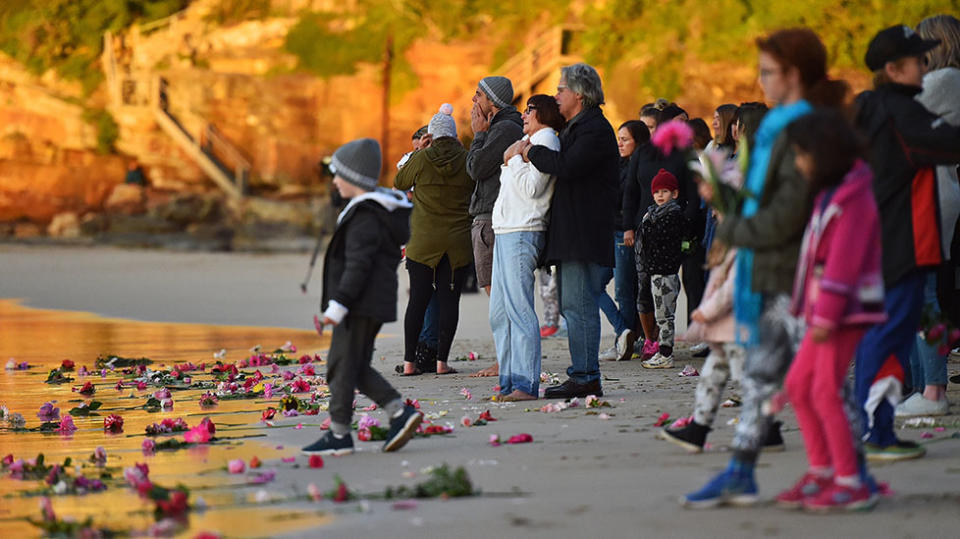 John Ruszczyk and Maryan Heffernan are seen embracing at the water’s edge during a vigil for their daughter at Freshwater Beach in Sydney. Source: Getty