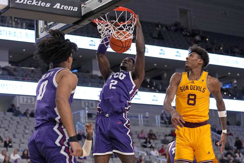 TCU forward Emanuel Miller (2) dunks after getting past Arizona State forward Alonzo Gaffney (8), while TCU's Micah Peavy (0) watches during the first half of an NCAA college basketball game in Fort Worth, Texas, Saturday, Dec. 16, 2023. (AP Photo/Tony Gutierrez)