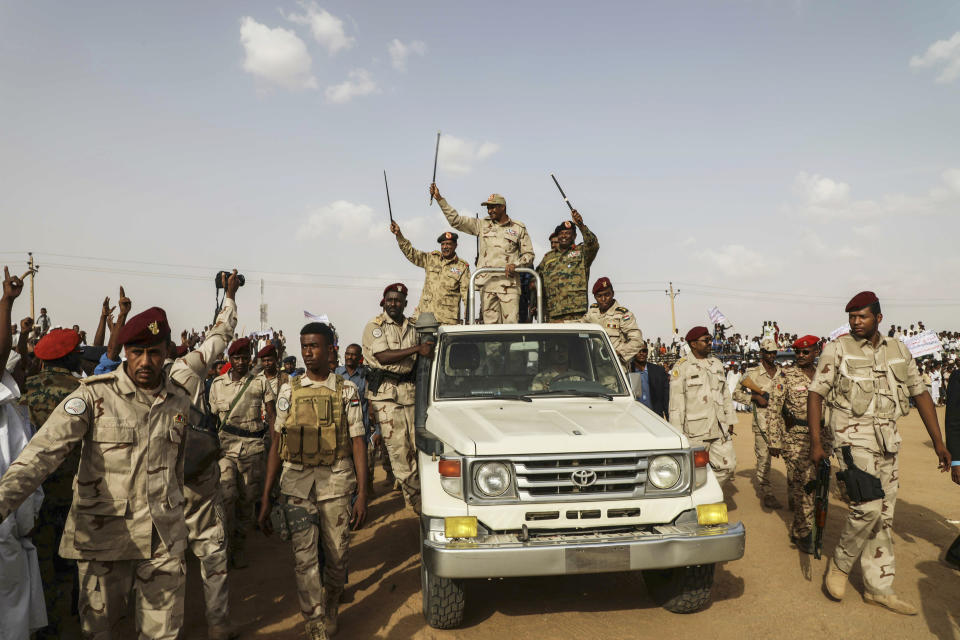 File - Gen. Mohammed Hamdan Dagalo, the deputy head of the military council, waves to a crowd during a military-backed tribe's rally, in the Nile River State, Sudan, Saturday, , on July 13, 2019. The US is making efforts to convince power brokers in Libya and Sudan to expel the Russian private military company Wagner, regional officials tell The Associated Press. The pressure comes after Washington expanded sanctions on the group. Wagner has played a role in Libya's conflict but has also been linked with a powerful Sudanese paramilitary. (AP Photo/Mahmoud Hjaj, File)