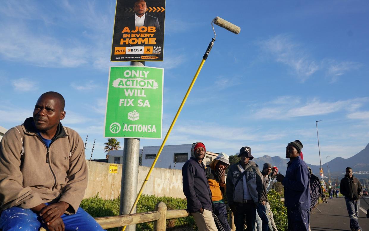 Unemployed men line a street in Cape Town, hoping for some casual work