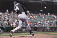 Colorado Rockies' Ryan McMahon (24) hits a two-run home run against the San Francisco Giants during the fifth inning of a baseball game in San Francisco, Saturday, April 10, 2021. (AP Photo/Jeff Chiu)