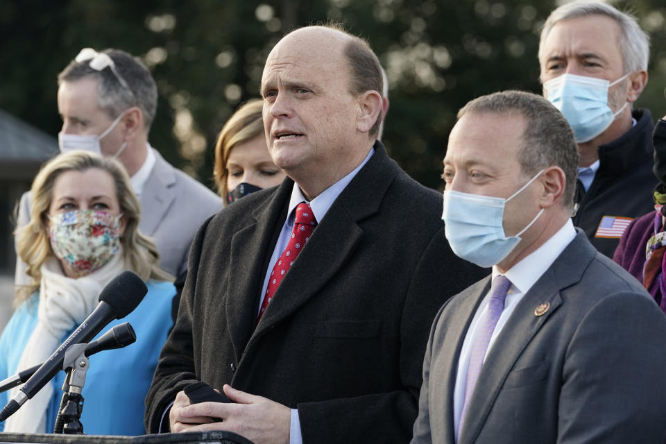 Problem Solvers Caucus co-chairs Rep. Tom Reed, R-N.Y., center, and Rep. Josh Gottheimer, D-N.J., right, speak to the media with members of their caucus about the expected passage of the emergency COVID-19 relief bill, Monday, Dec. 21, 2020, on Capitol Hill in Washington. Congressional leaders have hashed out a massive, year-end catchall bill that combines $900 billion in COVID-19 aid with a $1.4 trillion spending bill and reams of other unfinished legislation on taxes, energy, education and health care. (AP Photo/Jacquelyn Martin)