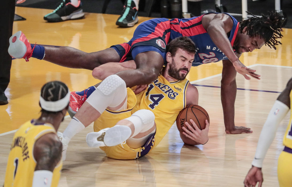 Marc Gasol, por los suelos con la pelota agarrada y un jugador rival cayendo encima de él.