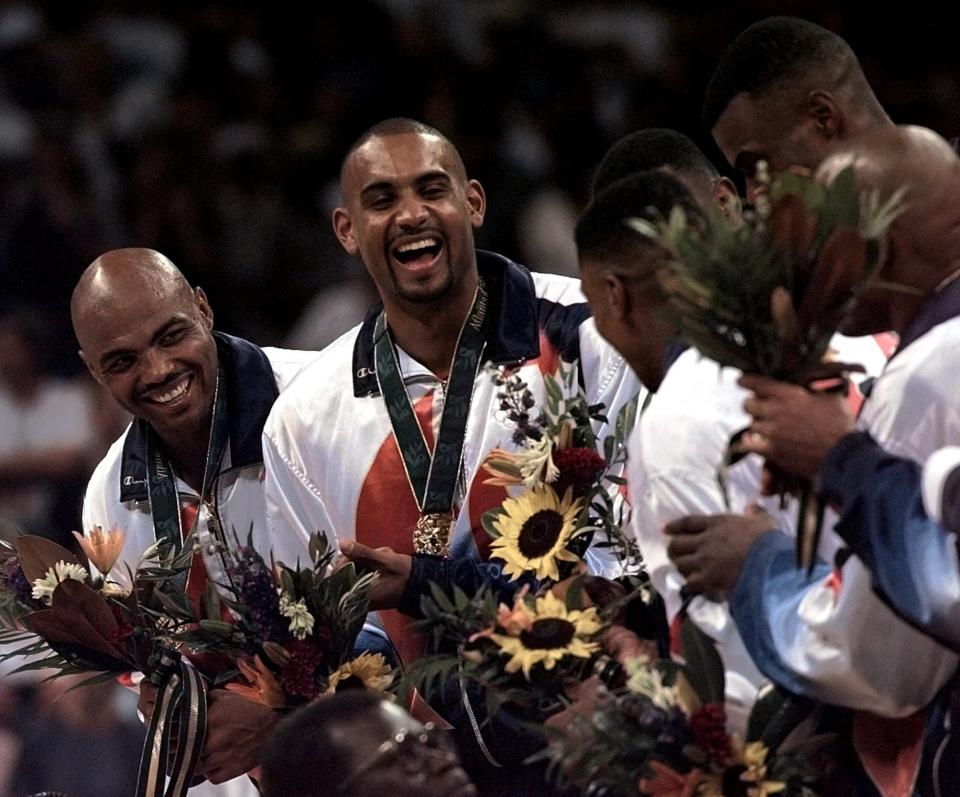 FILE - In this Aug. 3, 1996 file photo, Dream Team members Charles Barkley, left, and Grant Hill share a laugh with teammates after receiving their gold medals at the Centennial Summer Olympic Games in Atlanta. USA Basketball announced Saturday, April 3, 2021, that Hill will take over as managing director of the men’s national team after this summer’s Tokyo Olympics. (AP Photo/Hans Deryk, File)