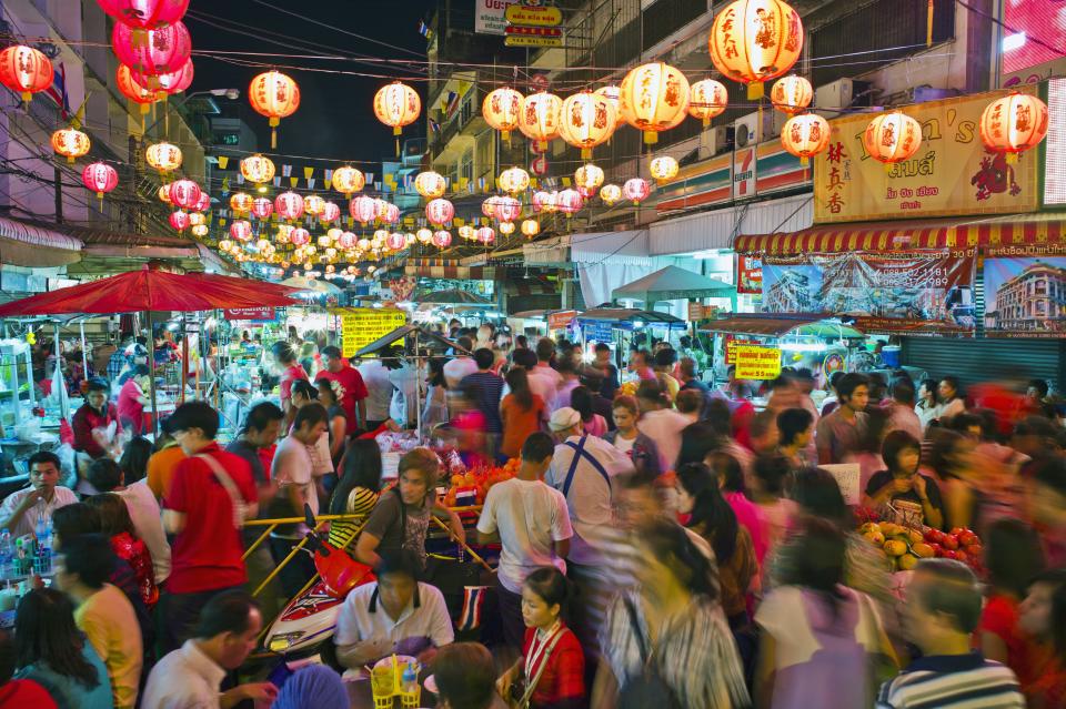 Thailand, Bangkok, China town during Chinese New Year, busy night market, crowds of people shopping.
