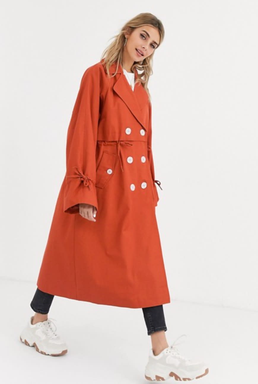 ASOS DESIGN luxe contrast button trench coat in rust (photo via ASOS)