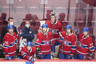 Montreal Canadiens players look on from the bench during the closing seconds of the third period of NHL hockey action against the Anaheim Ducks in Montreal, Thursday, Jan. 27, 2022. (Graham Hughes/The Canadian Press via AP)