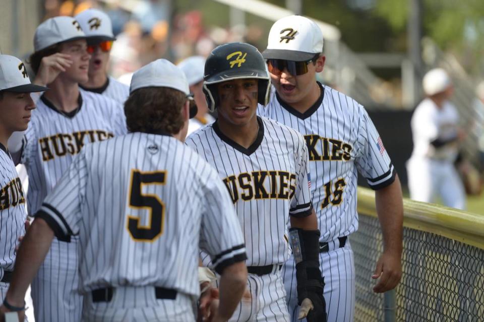 Hughson’s JC Lupercio greets his teammates after scoring a run during a Trans Valley League game against Ripon at Ripon High School in Ripon, Calif. on April 18, 2024.