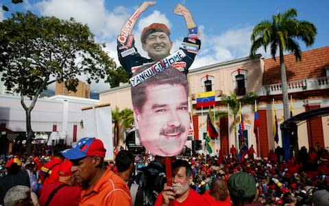 Government supporters are celebrating the 20th anniversary of Hugo Chavez's rise to power - Credit: Ariana Cubillos/AP