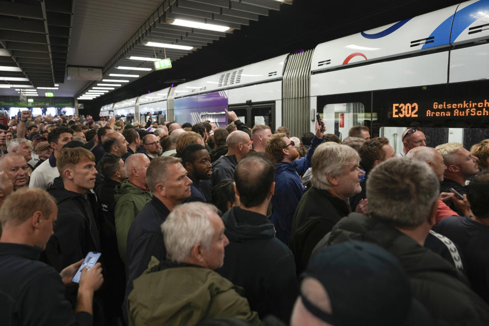 Soccer fans gather on train station ahead the Group C match between Serbia and England at the Euro 2024 soccer tournament in Gelsenkirchen, Germany, Sunday, June 16, 2024. (AP Photo/Markus Schreiber)