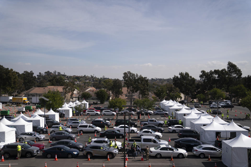 Motorists line up for their COVID-19 vaccine a joint state-federal mass vaccination site set up on the campus of California State University of Los Angeles in Los Angeles, Tuesday, Feb. 16, 2021. (AP Photo/Jae C. Hong)