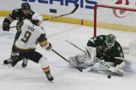 Minnesota Wild's goalie Kaapo Kahkonen (34) blocks a shot-attempt by Vegas Golden Knights' Cody Glass (9) in the third period of an NHL hockey game Monday, March 8, 2021, in St. Paul, Minn. (AP Photo/Stacy Bengs)