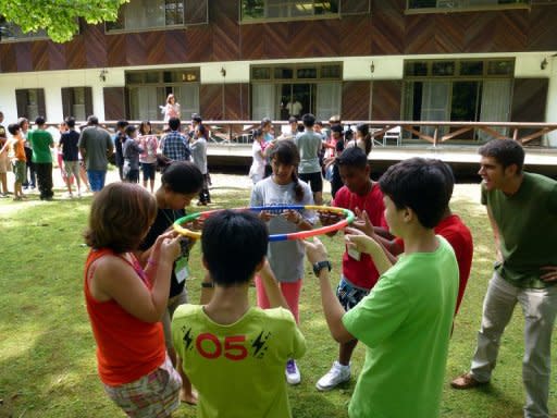 53 students from 14 countries are seen holding hoops with their fingers as part of a cooperation learning exercise at a class of the International School of Asia, Karuizawa (ISAK) at Japan's mountain resort town Karuizawa in Nagano prefecture, central Japan