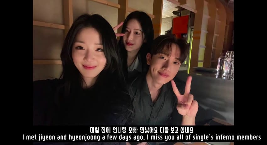 A selfie taken by Ji-yeon with Hyeon-joong and Min-ji in the back doing peace signs