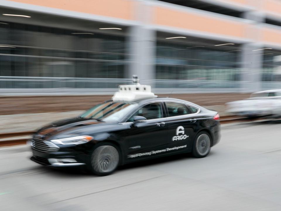 One of the test vehicles from Argo AI, Ford's autonomous vehicle unit, navigates through the strip district near the company offices in Pittsburgh.