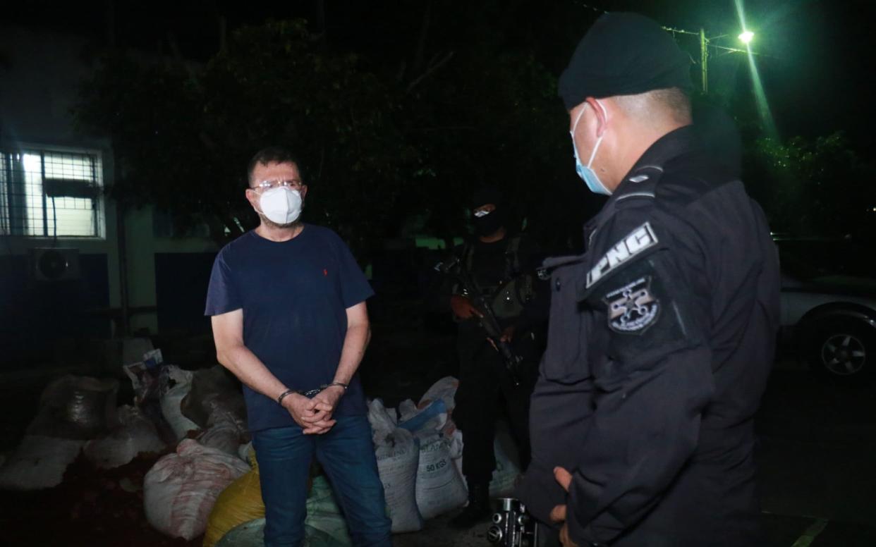 Former defense minister David Munguia Payes handcuffed after the Attorney General's Office (FGR) ordered his capture for alleged crimes of illegal groups - AFP