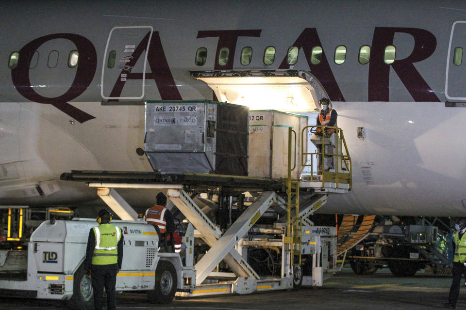 The first arrival of COVID-19 vaccines to Kenya is offloaded from a Qatar Airways flight at Jomo Kenyatta International Airport in Nairobi, Kenya, early Wednesday, March 3, 2021. Around 1.02 million doses of the AstraZeneca COVID-19 vaccine manufactured by the Serum Institute of India arrived at the airport as part of the COVAX facility, according to the Ministry of Health. (AP Photo)