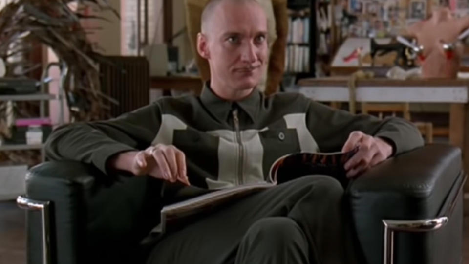 David Thewlis reading a magazine and smiling