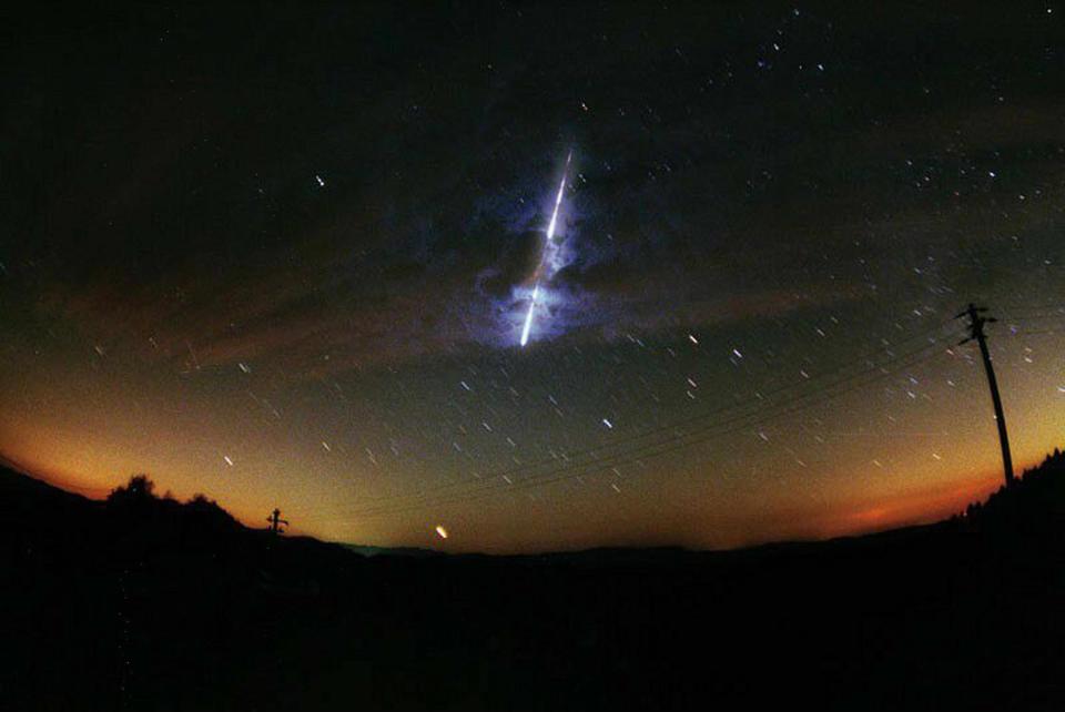 This November 2000 NASA file image shows a meteor streaking across the sky during the Leonid meteor shower. Earth runs into this trail of uneven comet exhaust every year, and the particles strike Earth's outer atmosphere and burn up. The shooting stars of the Leonid shower appear to be arriving from inside the constellation Leo, the Lion.