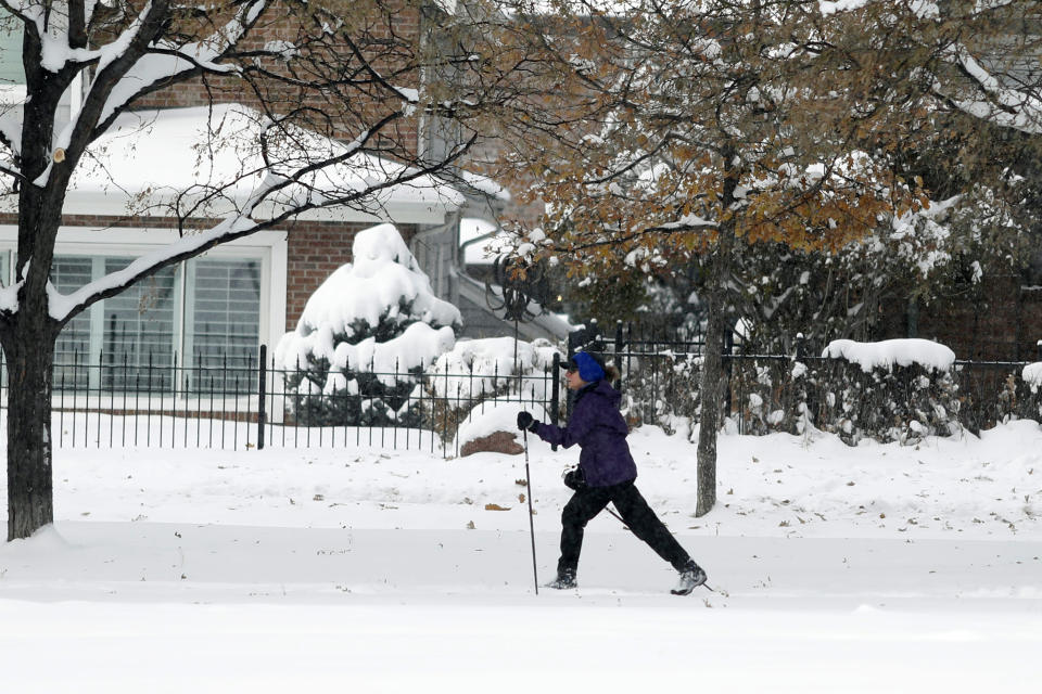 A cross-country skier moves through Washington Park as an autumn snowstorm sweeps over the intermountain West, Tuesday, Oct. 29, 2019, in Denver. Forecasters predict that this second storm in two days will bring up to a foot of snow in some places in the region as well as pack an intense cold that may drop temperatures to possibly record-setting lows. (AP Photo/David Zalubowski)
