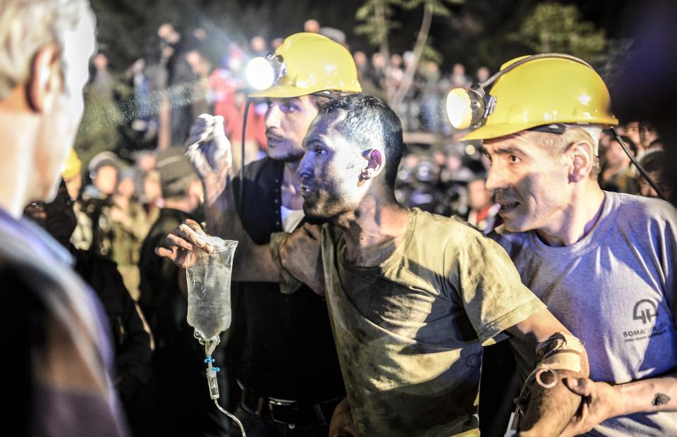A miner came out helped by friends after an explosion in Manisa on May 13, 2014. (BULENT KILIC/AFP/Getty Images)