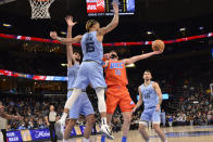 Oklahoma City Thunder guard Ty Jerome (16) shoots against Memphis Grizzlies forwards Brandon Clarke (15) and Santi Aldama, front left, in the first half of an NBA basketball game Thursday, Dec. 2, 2021, in Memphis, Tenn. (AP Photo/Brandon Dill)