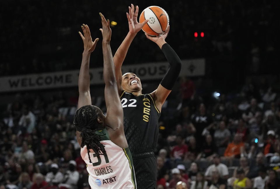 Las Vegas Aces forward A'ja Wilson (22) shoots over Seattle Storm's Tina Charles during the first half in Game 1 of a WNBA basketball semifinal playoff series Sunday, Aug. 28, 2022, in Las Vegas. (AP Photo/John Locher)