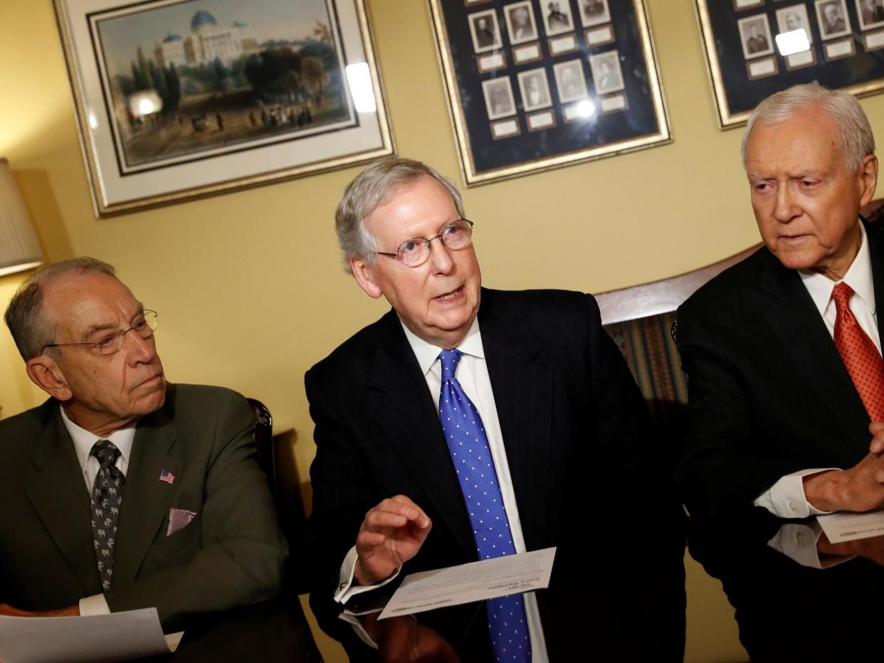 Senators Chuck Grassley (left) and Orrin Hatch (right) with Senate Majority Leader Mitch McConnell introducing the Republican tax reform plan at the US Capitol in Washington: Aaron P. Bernstein/Reuters