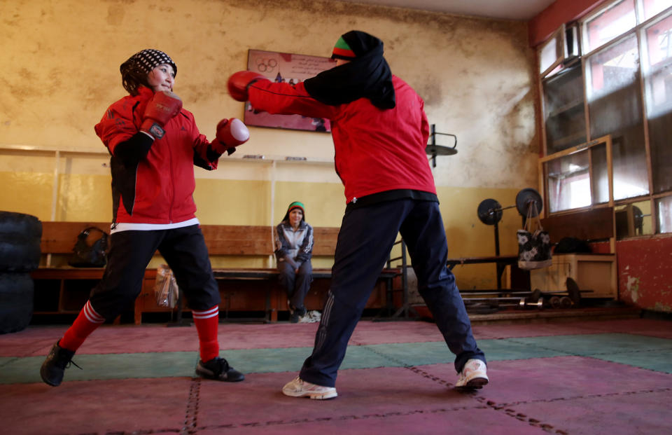 In this Wednesday, March, 5, 2014 photo, Afghan female boxers practice at the Kabul Stadium boxing club, Afghanistan. The women, who are 18 and older, don’t have much more than determination, and a trainer who runs them through their paces, watches as they spar, corrects their technique, tells them when to jab, how to protect themselves, when to power through with a left and then a right. (AP Photo/Massoud Hossaini)