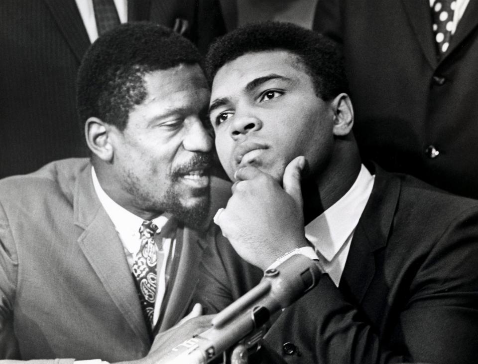 Professional basketball player Bill Russell, left, speaks with boxer Muhammad Ali during a news conference of top Black athletes in support of Ali's refusal to fight in Vietnam on June 4, 1967, in Cleveland.