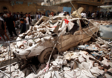 People gather at the site of an air strike launched by the Saudi-led coalition in Sanaa, Yemen May 16, 2019. REUTERS/Mohamed al-Sayaghi