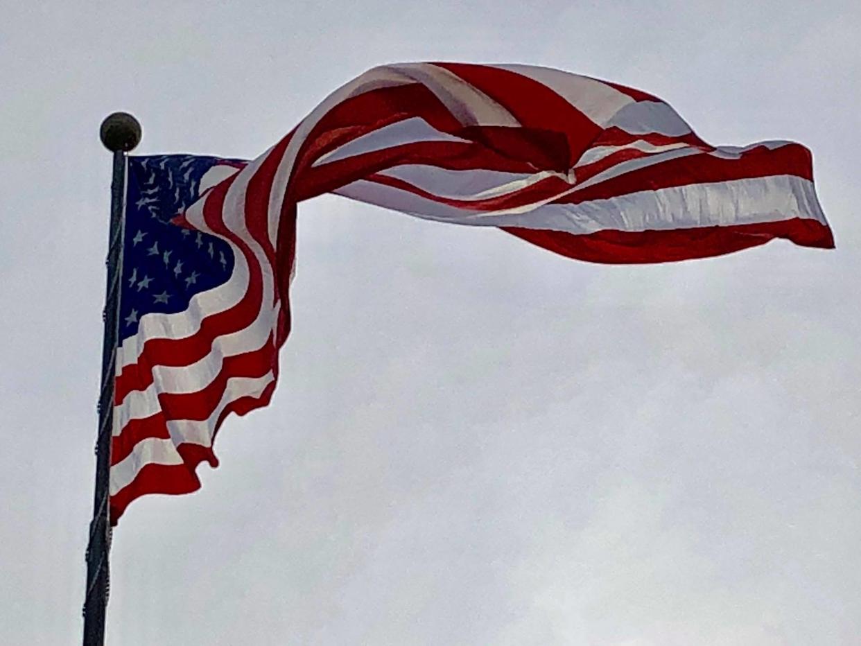 A 40-foot x 76-foot majestic U.S. flag soars to honor members of the military, past and present, at USA Iron and Metal in Chester, Virginia.