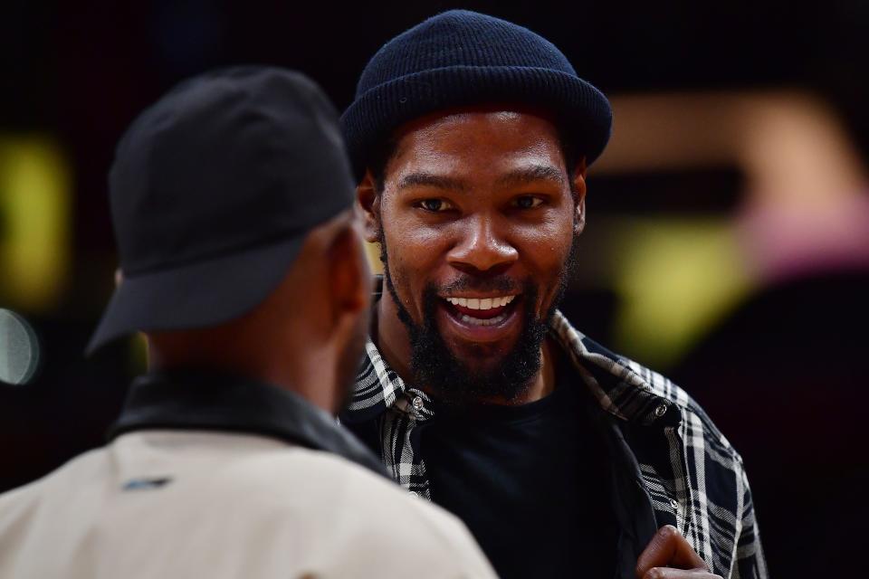 Phoenix Suns forward Kevin Durant (35) speaks with guard Chris Paul (3) during a time out in the first half at Crypto.com Arena in Los Angeles on April 7, 2023.